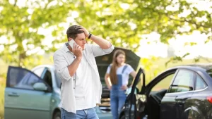 a man talking on the phone after car accident