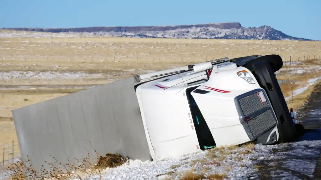 Truck overturned in a field after an accident.